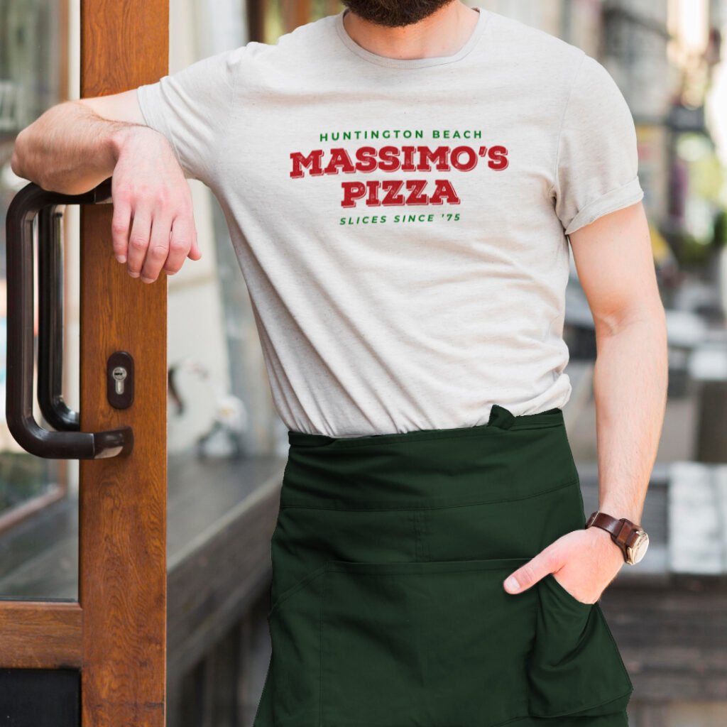Massimo’s Pizza rebrand logo on staff t-shirt and green apron.